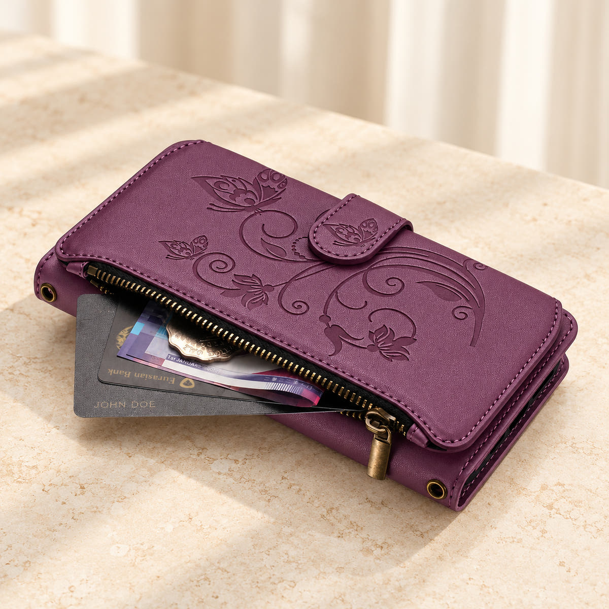 Velora Zip wallet case in Plum on cream limestone, showing the embossed front and open side zip pocket with cards and cash.