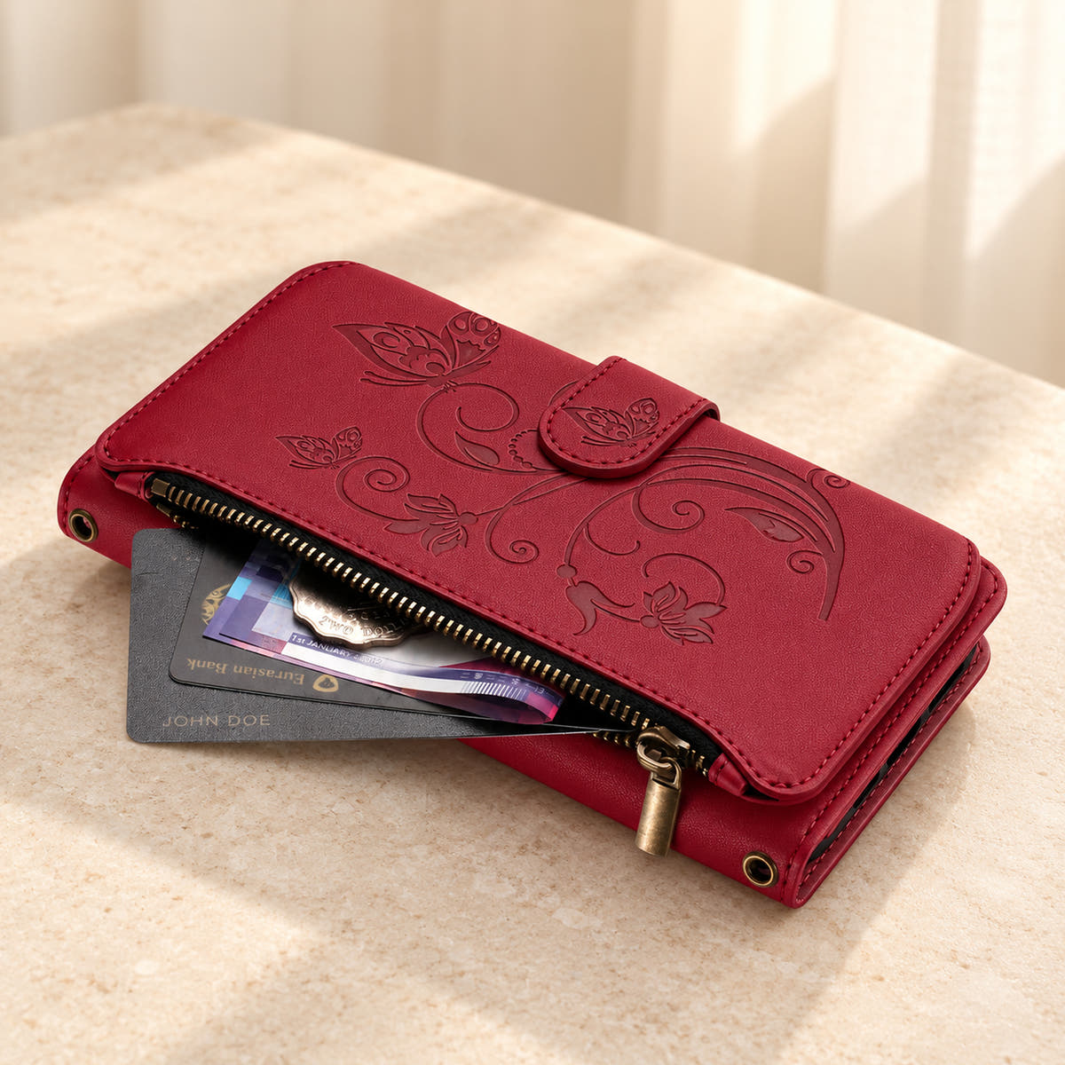 Velora Zip wallet case in Red on cream limestone, showing the embossed front and open side zip pocket with cards and cash.