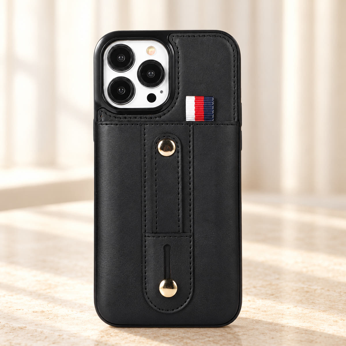 Black iPhone wallet case with card pocket and adjustable hand strap, hero