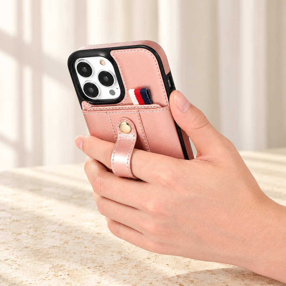 Pink iPhone wallet case with card pocket and adjustable hand strap, handgrip