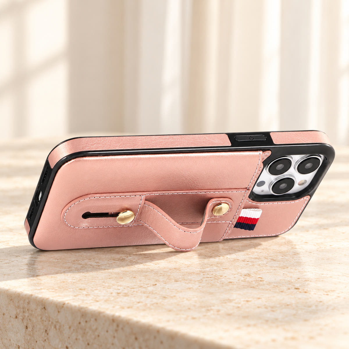 Pink iPhone wallet case with card pocket and adjustable hand strap, stand